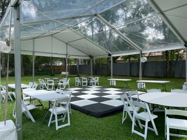 Backyard event with ACME tent, tables and dance floor
